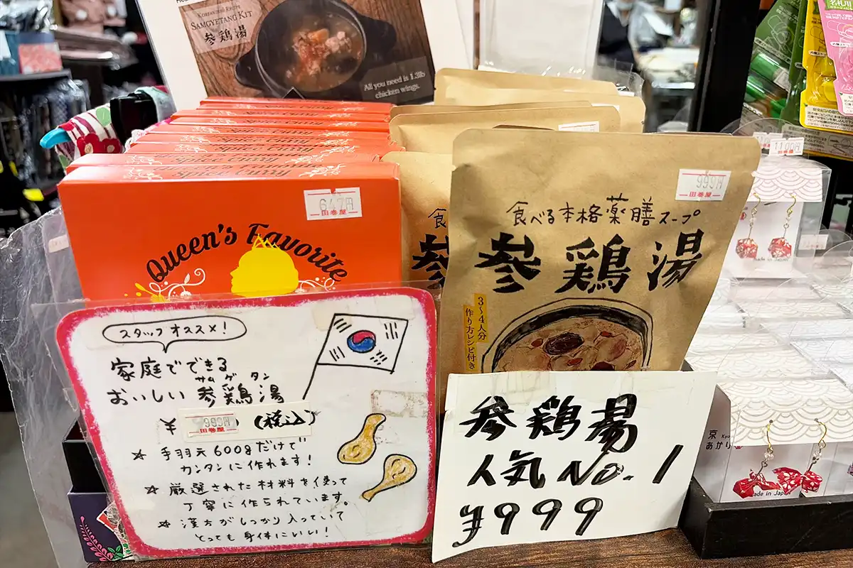 田巻屋の店内に並ぶ手書きポップ付きの本格薬膳スープ「参鶏湯」のパッケージ